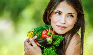 Segreti per come avere una pelle perfetta: una donna abbraccia verdure fresche, simbolo di benessere e bellezza naturale.