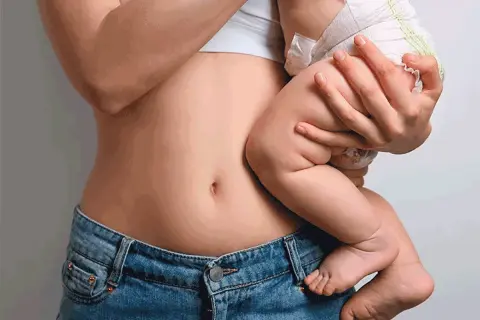 Pancia rovinata dopo il parto, ma un amore immenso che la riempie. La mamma abbraccia il suo bimbo.